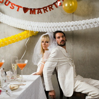 Newlywed Couple Tied up at Wedding Reception --- Image by © Ragnar Schmuck/Corbis