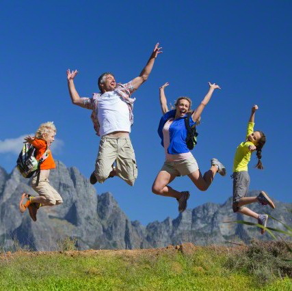 17 Nov 2014, Cape Town, South Africa --- Family jumping in the air on a mountain hiking trail --- Image by © Graham Oliver/Juice Images/Corbis